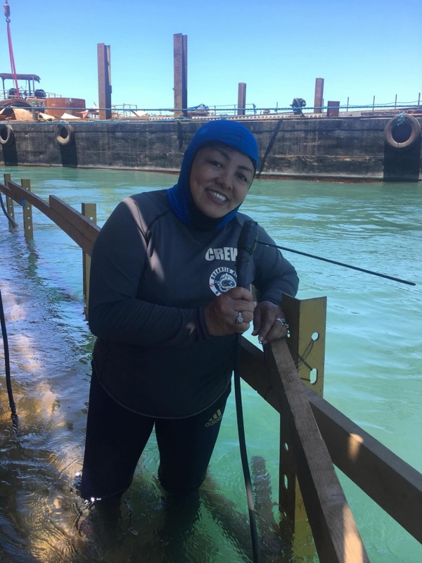 Smiling female crew member in the water during operations