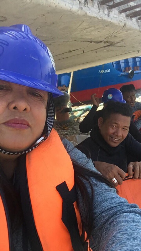 Two crew members in life vests under bridge during operations